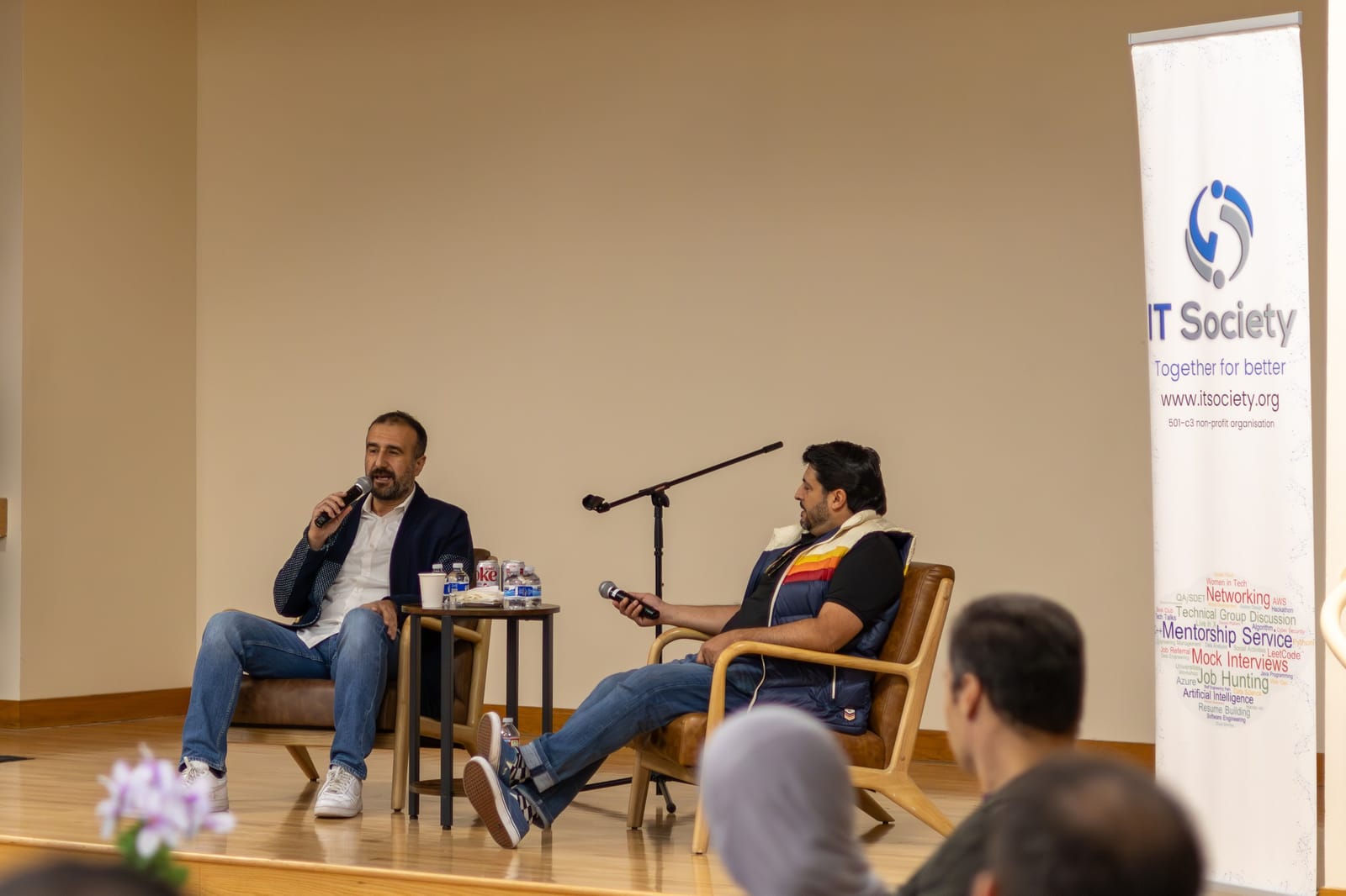 A conversation on stage in front of a full room.